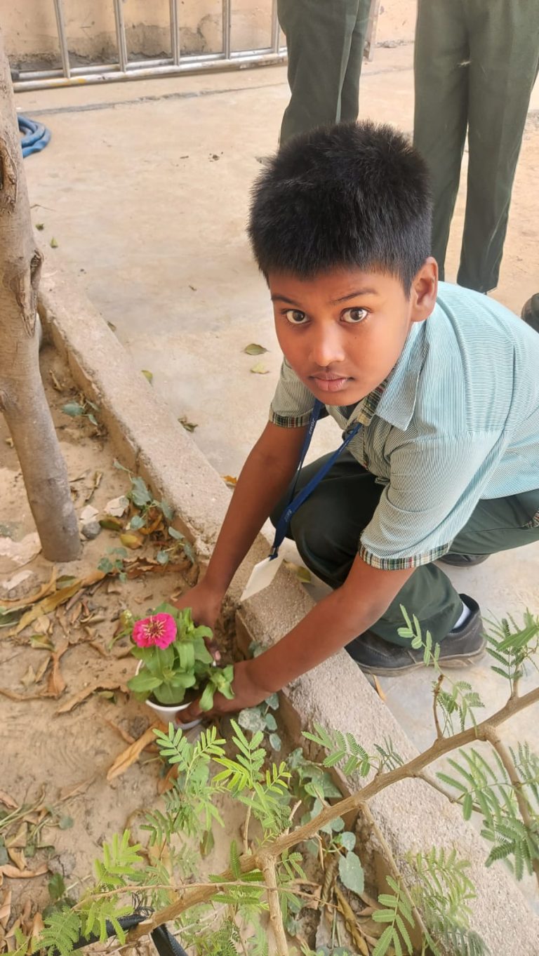 Student planting flowers in the school campus
