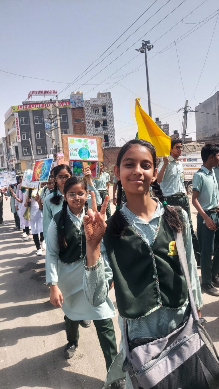 Students holding posters during Earth Day rally